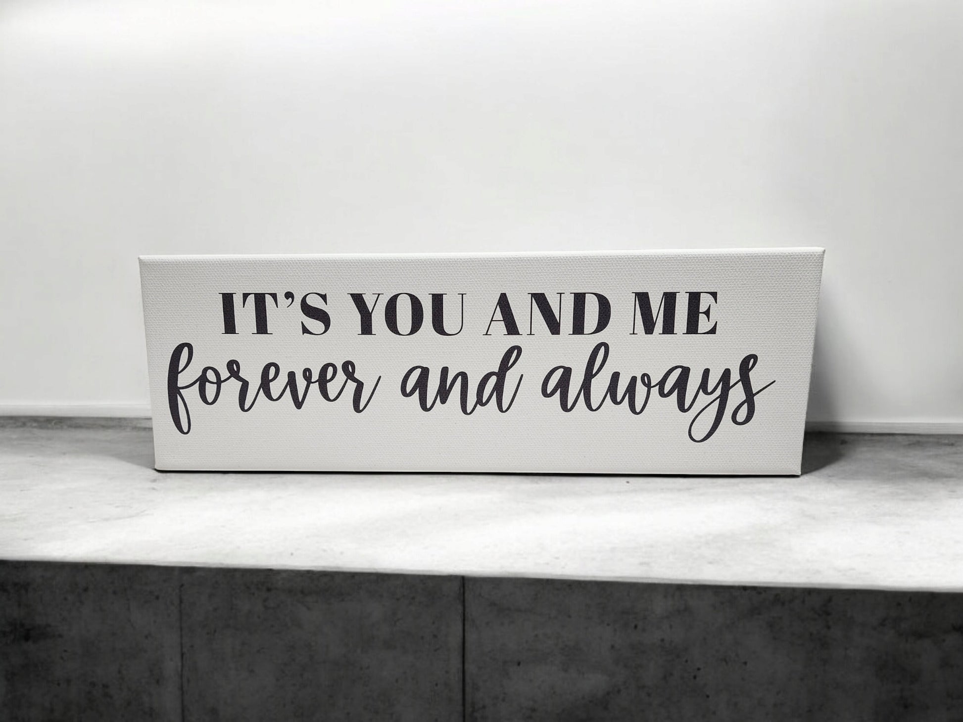 Mirabilia Boutique's 4x12 cradled canvas features "It's You and Me Forever and Always" in black script on a white and gray background, adding a timeless touch to your decor.