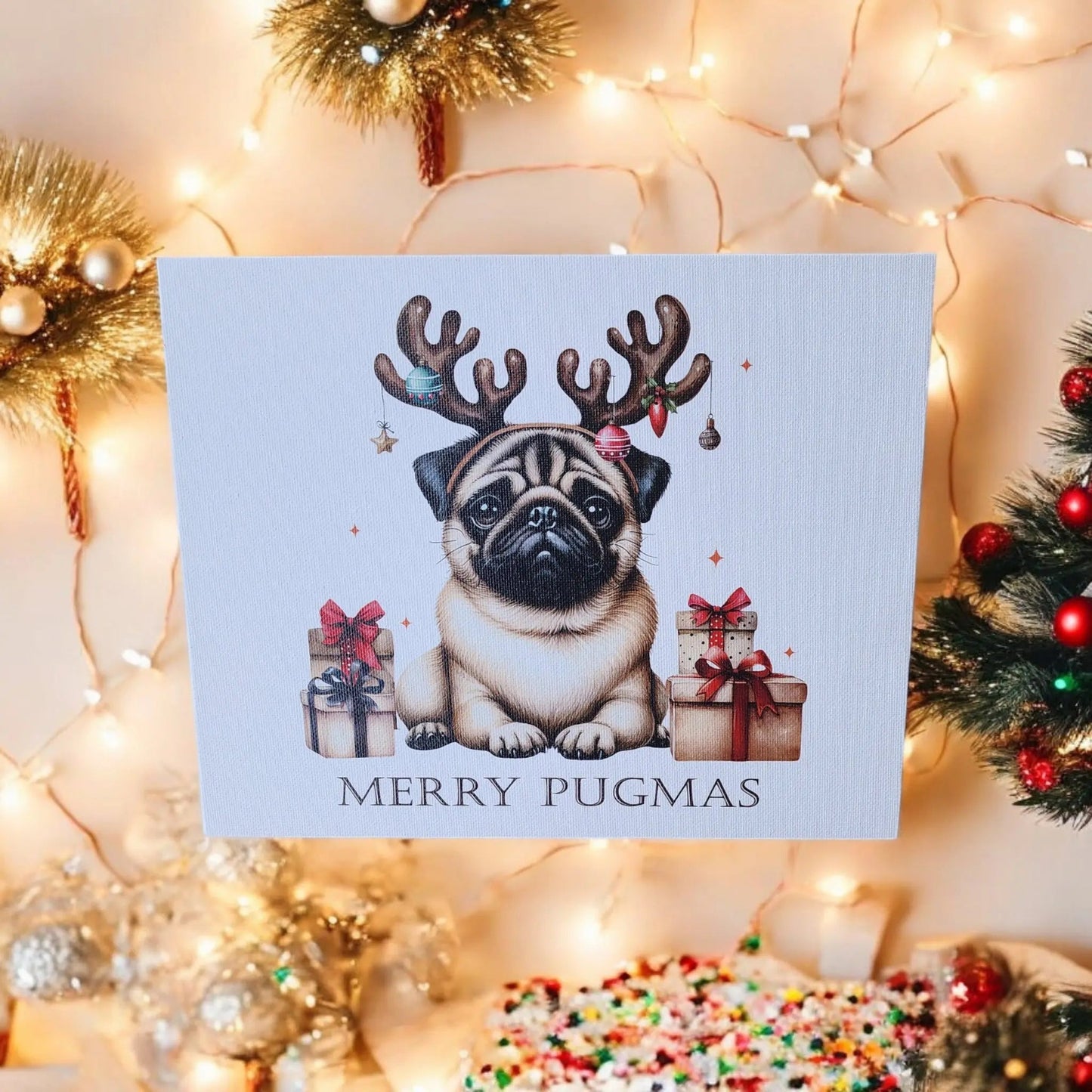 The Mirabilia Boutique's "Merry Pugmas" 10x8 Canvas Sign showcases a pug wearing antler headbands, sitting among gift boxes and festive decorations. The phrase "Merry Pugmas" is written below, with Christmas lights, ornaments, and a decorated tree in the background, making it an ideal piece for holiday decor.