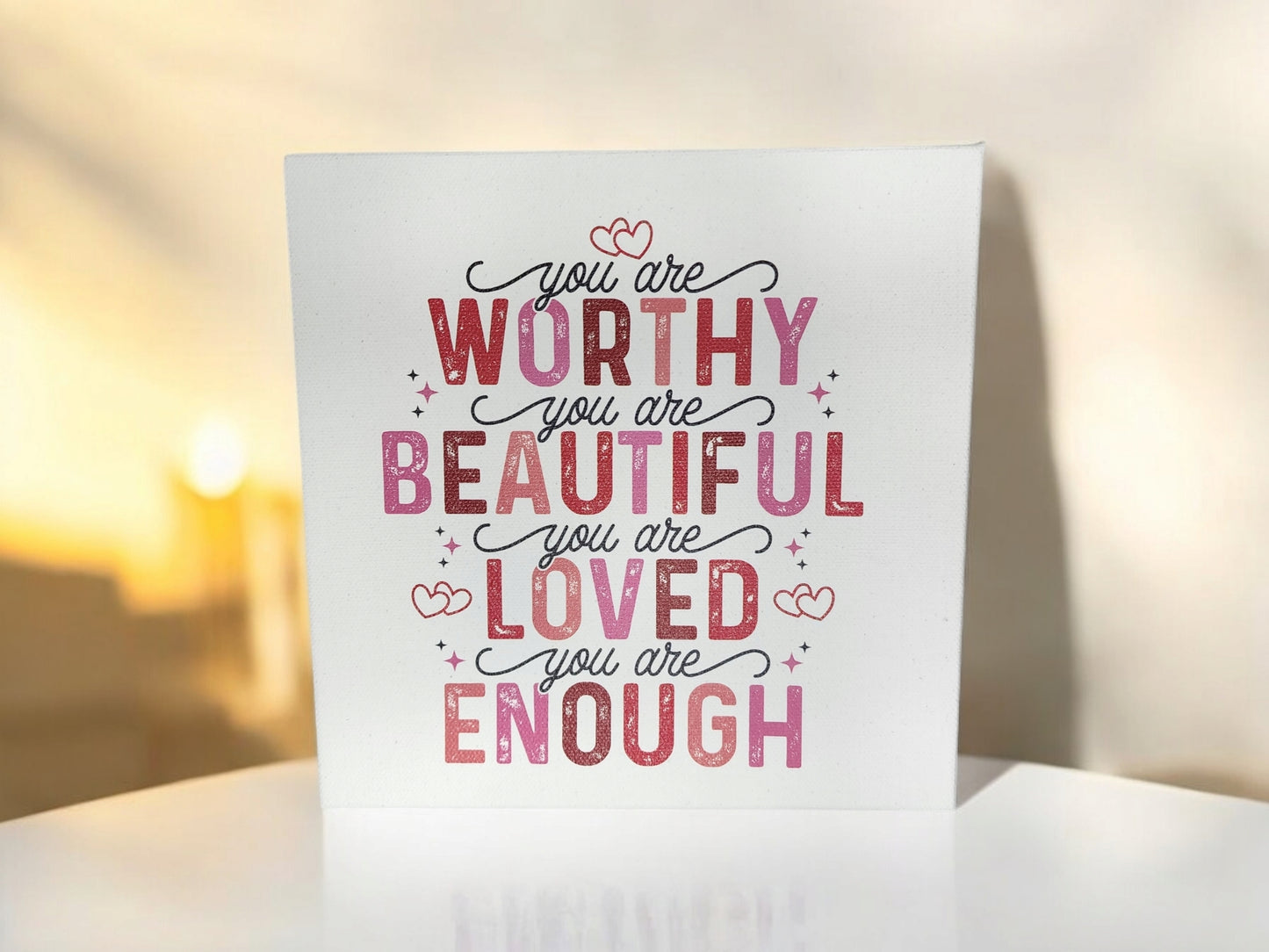 Mirabilia Boutique's 8x8 cradled canvas sign titled "You Are Worthy, Beautiful, Loved, Enough" features a warm-toned background with heart accents and an empowering affirmation in pink and red text.