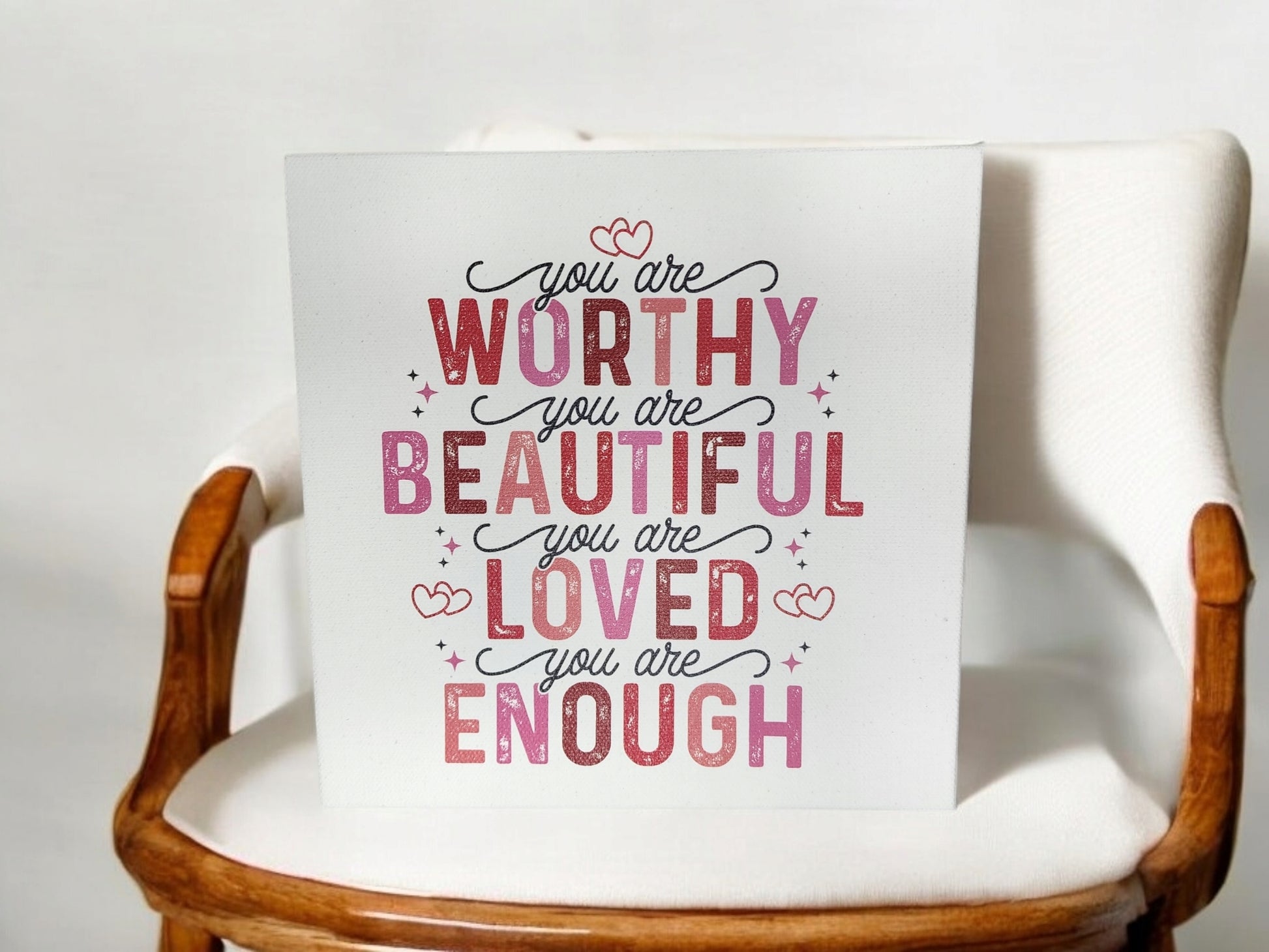 The "You Are Worthy, Beautiful, Loved, Enough" 8x8 cradled canvas sign from Mirabilia Boutique features an empowering affirmation in pink and red fonts with heart accents—an ideal addition for your home decor.